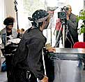 On location at the receptionist�s desk of the Turner Center: Film maker Michael Bundy is controlling the camera angle.